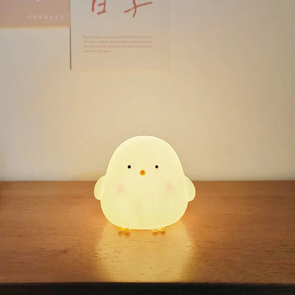 White silicone chick LED night light with round face and small feet