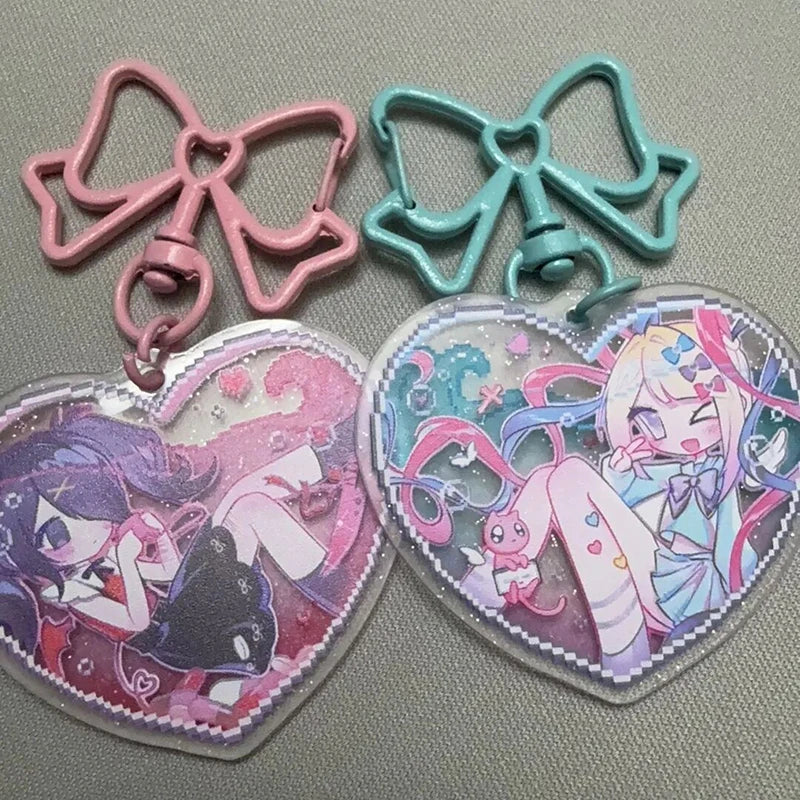 Acrylic heart keychains with pink and teal bow charms and character heart pendants