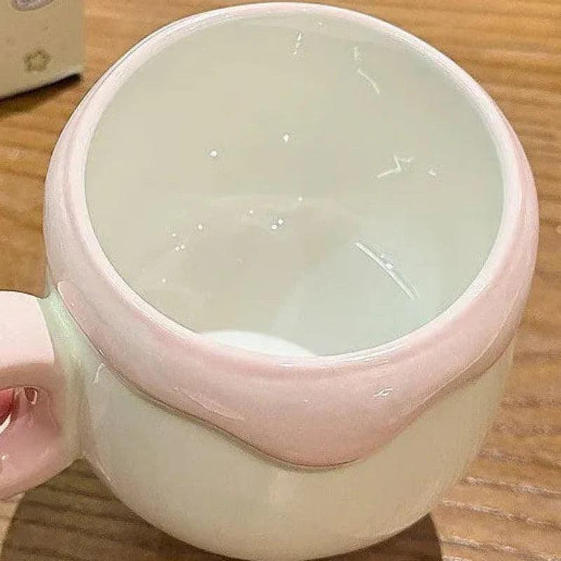 Ceramic pudding mug opening with pink rim and smooth white interior