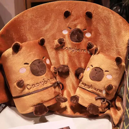 Rolled capybara blanket pillow set, orange plush with stitched face details and tie cords.