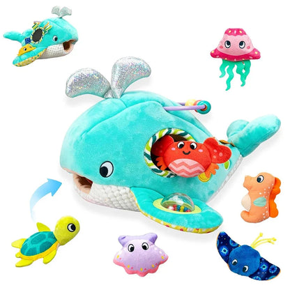 Turquoise plush ocean whale toy with attached sea animals and a hanging teether