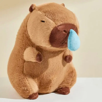 Seated brown capybara plush with droopy sad face and blue nose