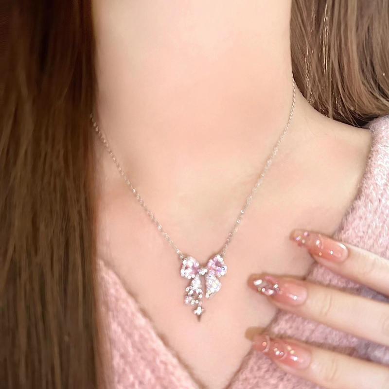 Bow pendant necklace on model, pink bow centerpiece with silver dangling charm