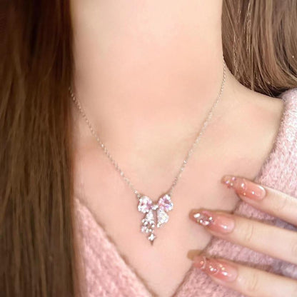Bow pendant necklace on model, pink bow centerpiece with silver dangling charm