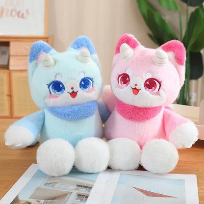 Light blue and pink dragon cat plush toys sitting side by side, cute big eyes