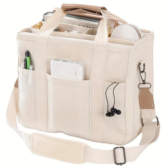 Beige canvas multi-pocket tote bag with adjustable shoulder strap and side key clip