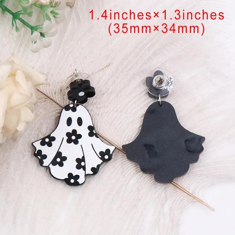 Ghost dangle earrings with black flower tops; one white floral ghost, one dark silhouette