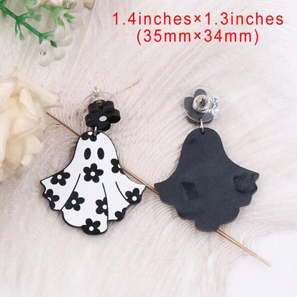 Ghost dangle earrings with black flower tops; one white floral ghost, one dark silhouette