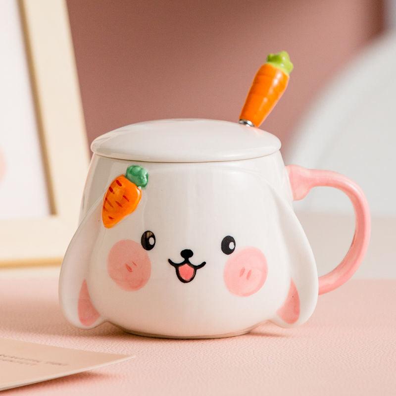 Rabbit ceramic mug with lid and carrot spoon, pink handle, bunny face on the front.