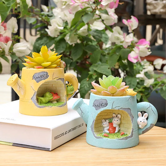 Resin watering can plant holder in yellow with frog garden scene and yellow succulent