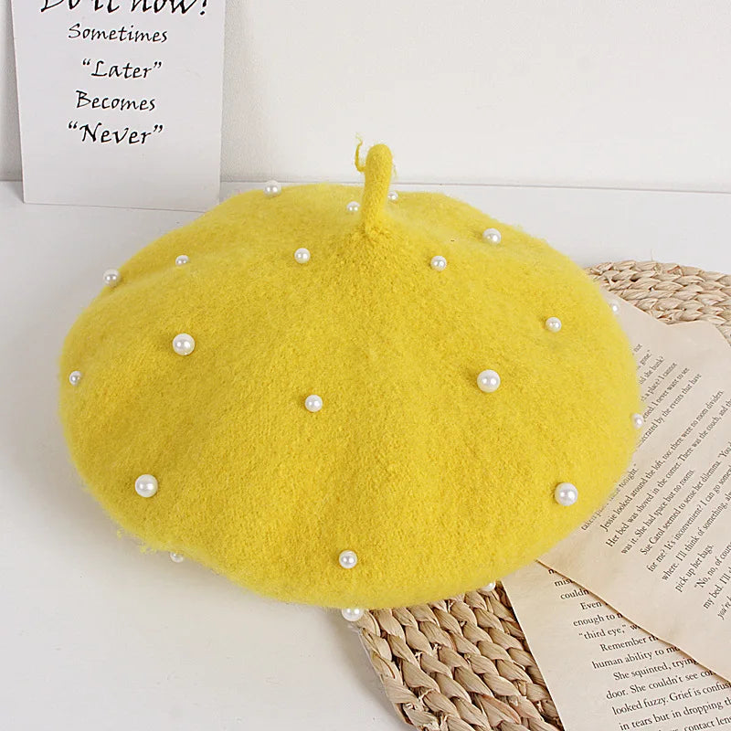 Yellow felt beret with faux pearl embellishments and a small center stem