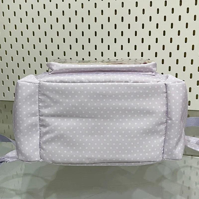 Light purple polka dot backpack back view with padded panel and folded top handle