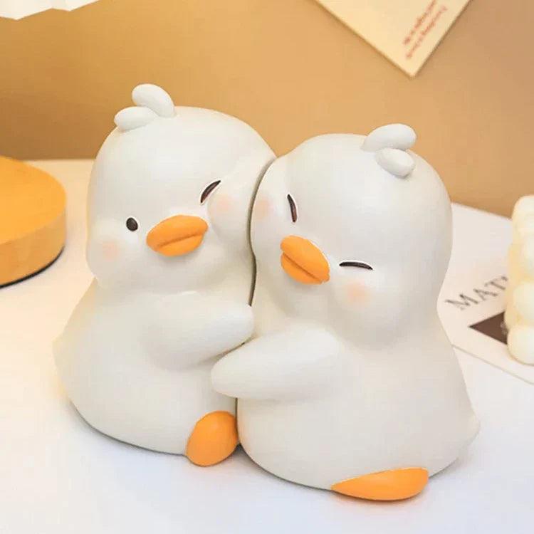 Pair of white duck book ends with orange beaks and feet