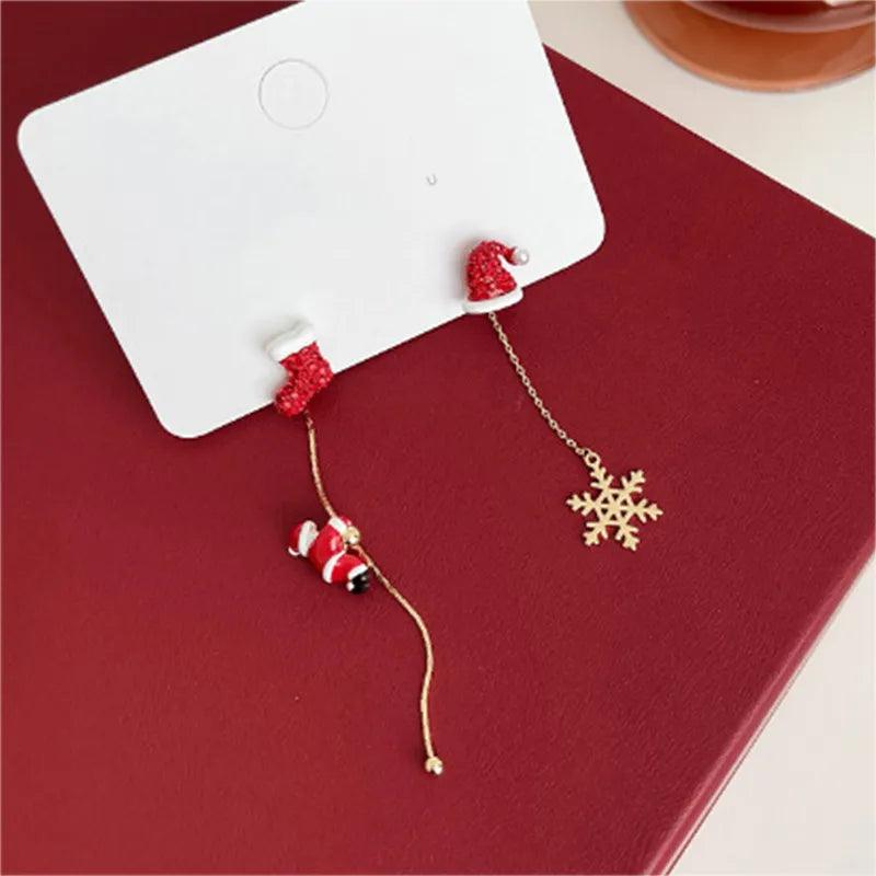 Holiday drop earrings on card: Santa charm and snowflake charm with gold-tone chain
