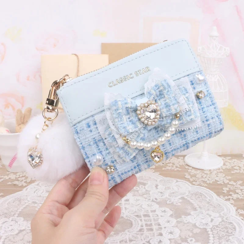 Blue quilted wallet with heart charm bow, pearl trim, and gold-tone zipper