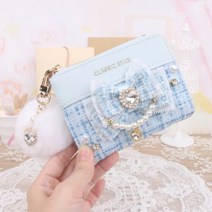 Blue quilted wallet with heart charm bow, pearl trim, and gold-tone zipper