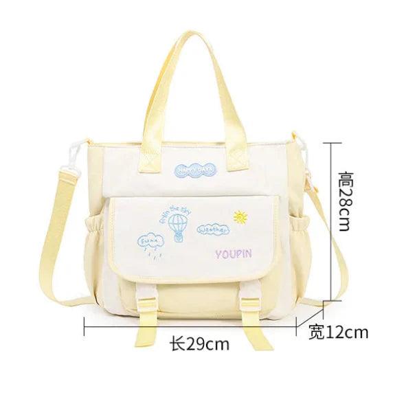 Kids tote bag in cream with front pocket and yellow strap, part of backpack set