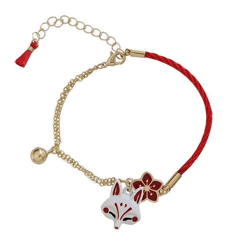 Gold link fox charm bracelet with red cord, fox head charm, and small dangling tassel