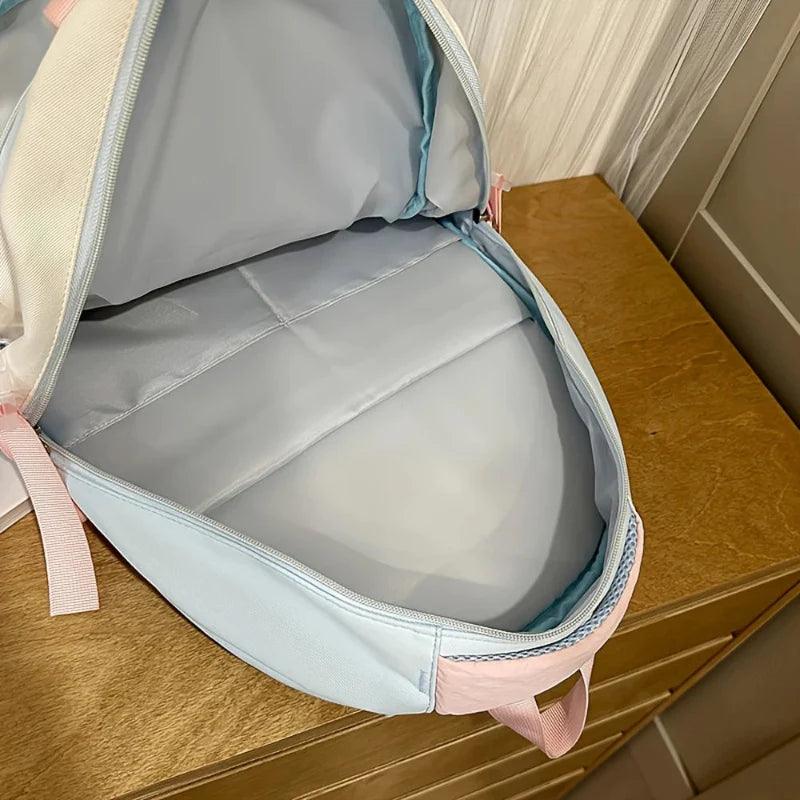 Pastel backpack with side zipper pocket open, showing empty inner compartment
