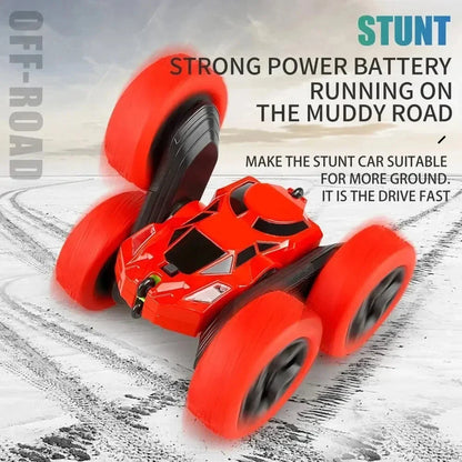 Red RC stunt car with oversized foam tires and handheld 2.4G remote controller