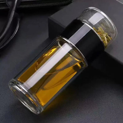 Clear storage bottle with amber contents and black sleeve, shown on fabric