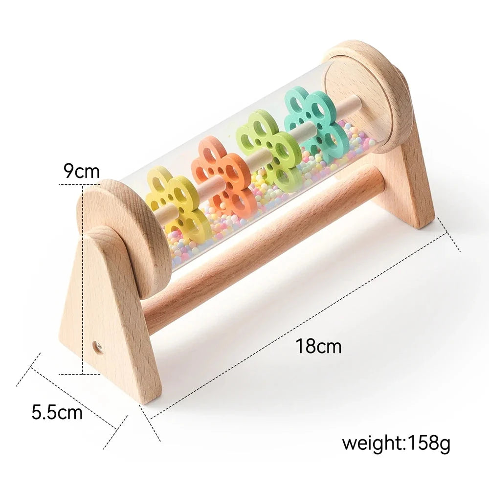 Wooden rain stick sensory toy with clear cylinder, colorful beads, and side measurements