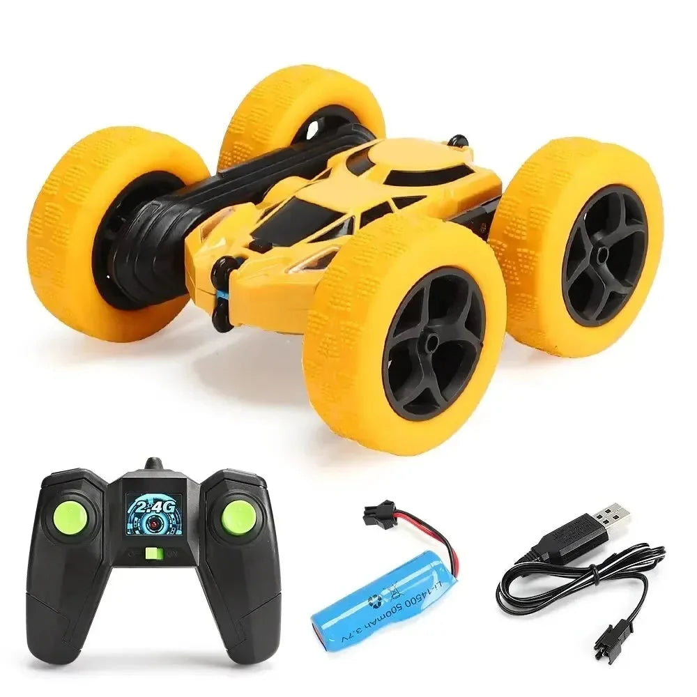 Yellow RC stunt car with oversized foam tires and 2.4G remote controller