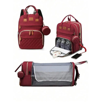 Red diaper bag backpack with foldable baby bed, bottle compartments, and pacifier holder.