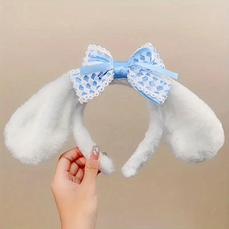 Plush bunny ear headband with white ears and light blue patterned lace bow.