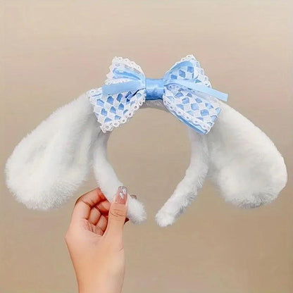 Plush bunny ear headband with white ears and light blue patterned lace bow.