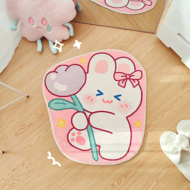Oval pink bear face area rug with bow, flower, and pastel rainbow accents
