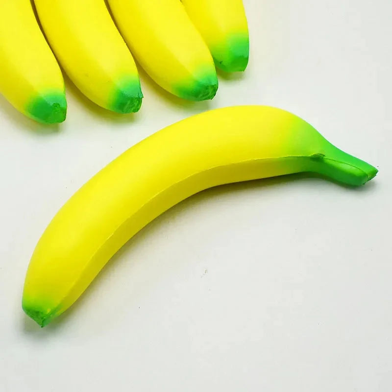 Single squishy banana toy close-up, yellow body with green bottom