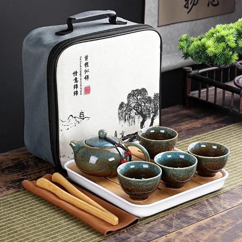 Portable Chinese kung fu tea set in gray carrying bag with green teapot and cups on tray