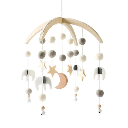 Baby crib mobile with gray and white pom-poms, crescent moon, stars, and unicorn