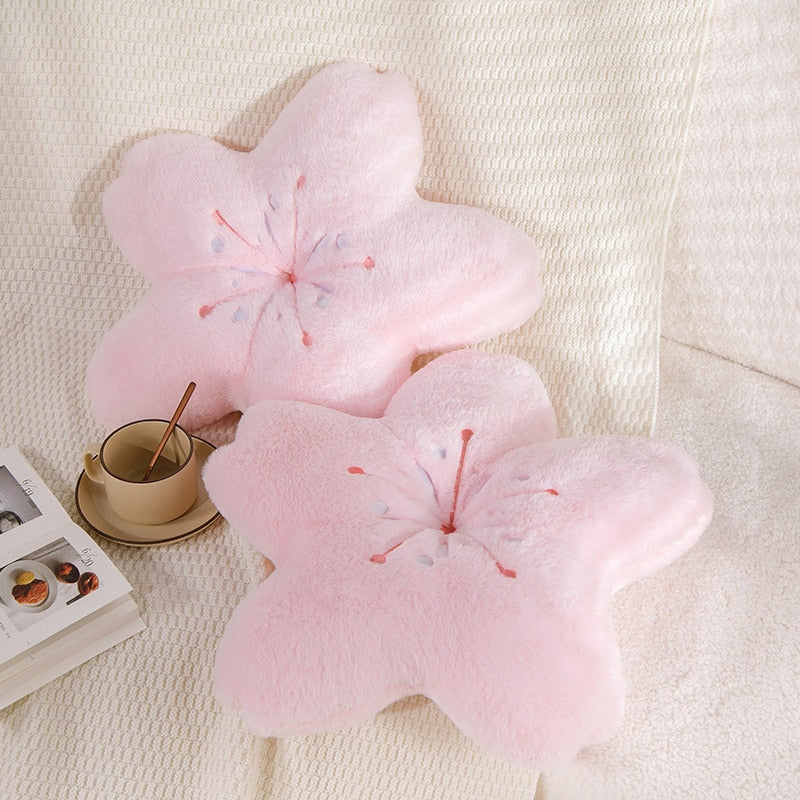 Pink cherry blossom plush pillow, two embroidered flower cushions on a light sofa