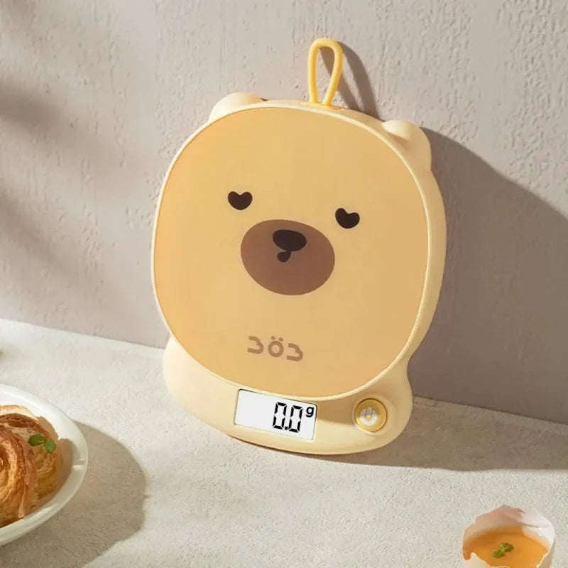 Yellow bear-face digital kitchen scale with LCD display and side control button