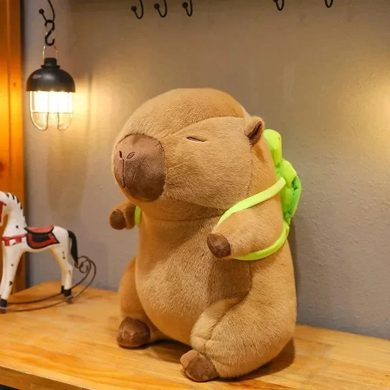 Tan plush capybara sitting with light green scarf and round nose detail