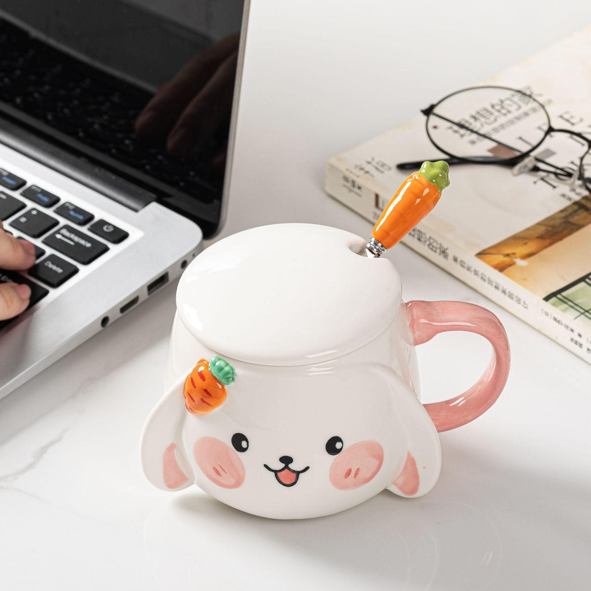 Rabbit ceramic mug with lid and carrot-shaped spoon, pink handle, white body.