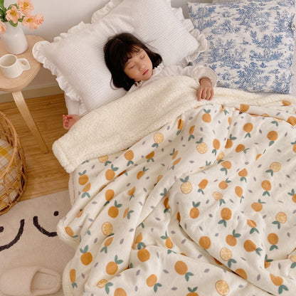 Lamb fleece blanket with cream base and orange fruit dot print, sherpa trim