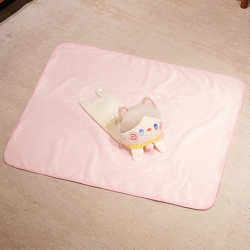 Pink cat pillow blanket with small cat emblem, folded flat blanket view