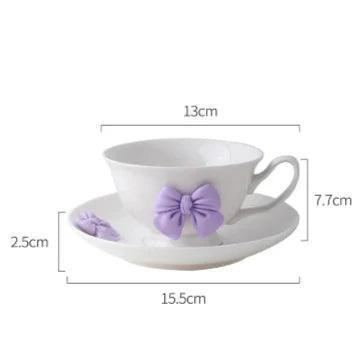 Tea cup and saucer dimensions diagram: white cup with purple bow, 13cm by 15.5cm