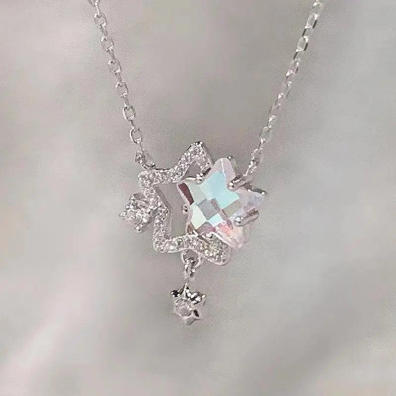 Silver-tone star pendant necklace with iridescent rhinestones and small dangling star charm