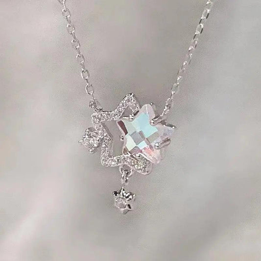 Silver-tone star pendant necklace with iridescent rhinestones and small dangling star charm