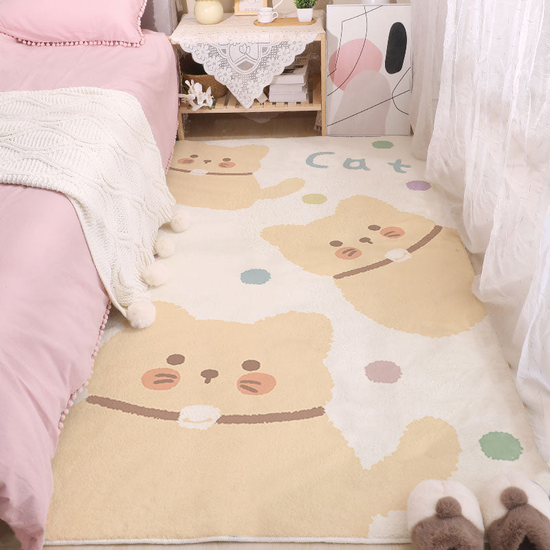 Cute animal face area rug in beige and cream with small green and blue details.