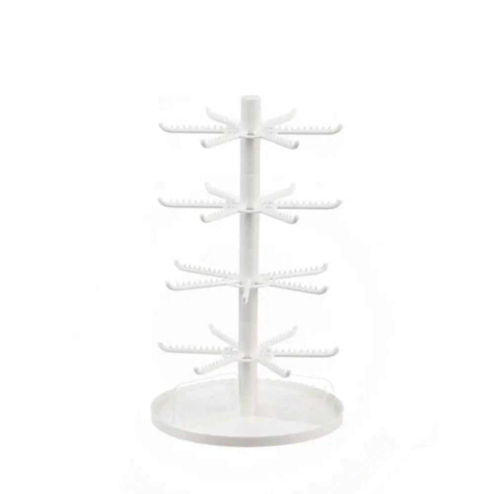 White rotating earring display stand with tiered hook arms and round base