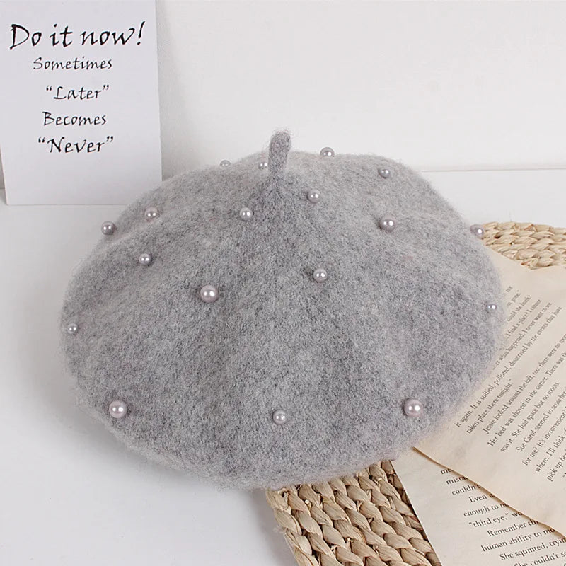Grey felt beret with faux pearl embellishments and a small center stem