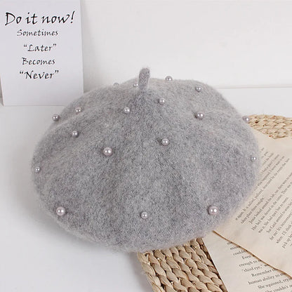 Grey felt beret with faux pearl embellishments and a small center stem
