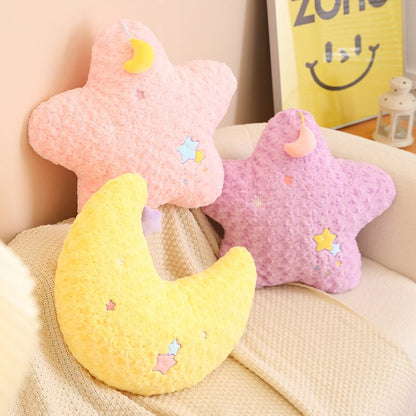 Pink star plush pillow with yellow moon crescent and small embroidered star accents