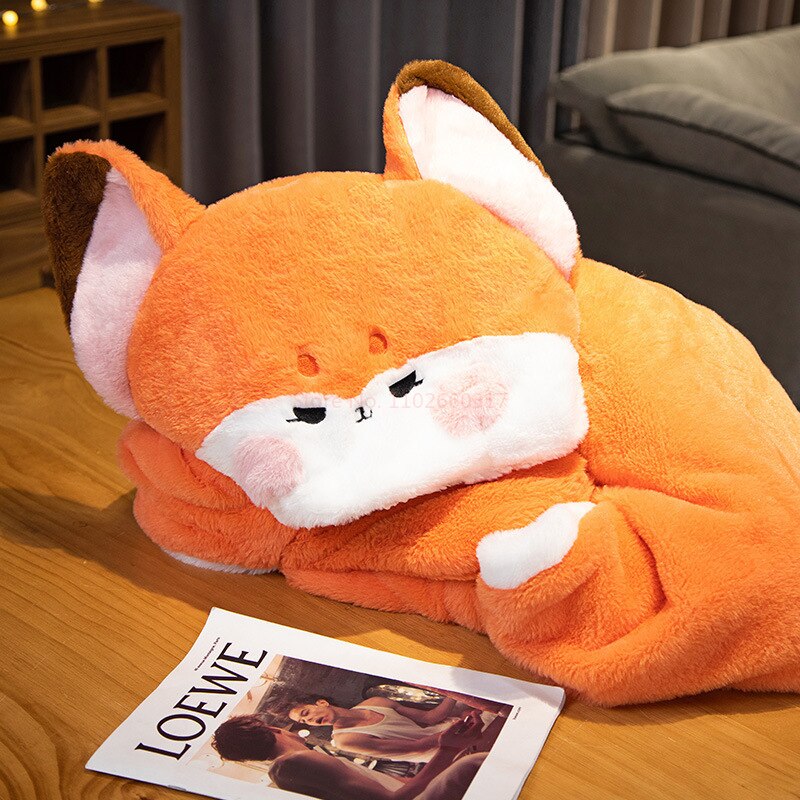 Orange fox blanket hoodie with plush fox hood and blanket drape, lying on wooden floor