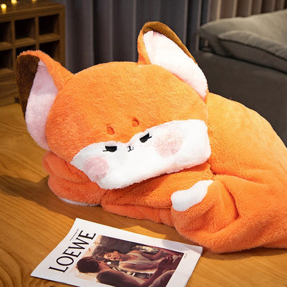 Orange fox blanket hoodie with plush fox hood and blanket drape, lying on wooden floor